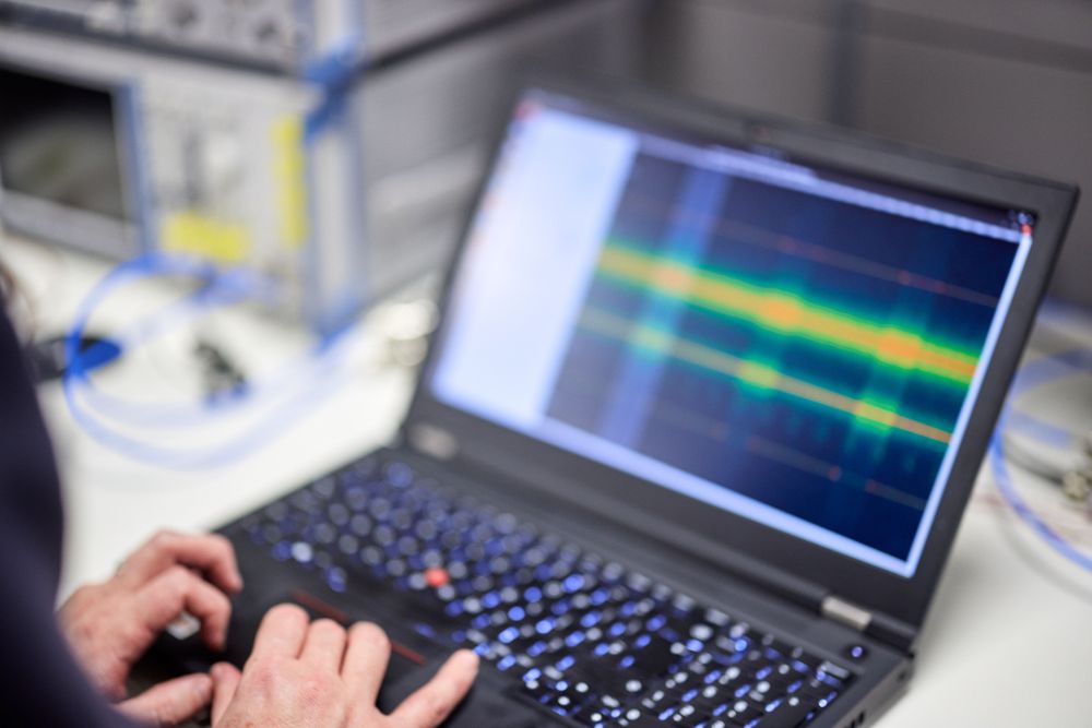 A laptop with waveforms.