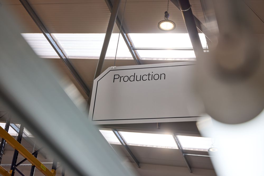 A sign saying Production in a warehouse.