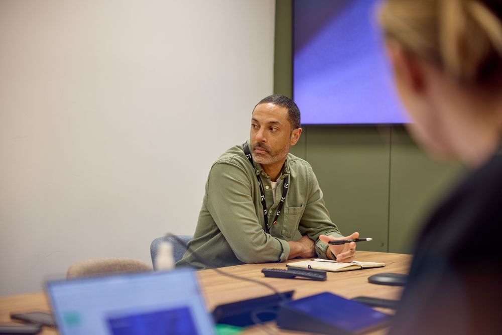 Rowden sales person sitting at a table during a meeting.